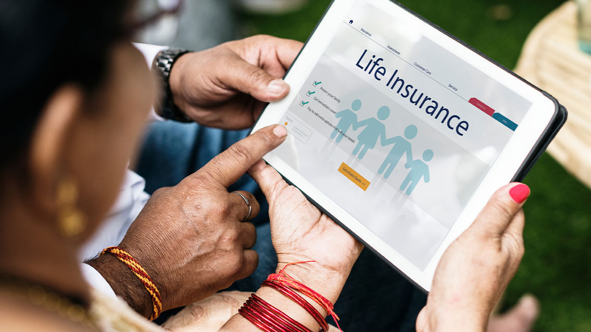 Mature woman looking down at a mobile tablet device displaying a life insurance policy