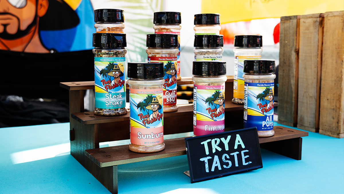 Those Florida Guys BBQ Rubs on tiered platforms with a try a taste sign