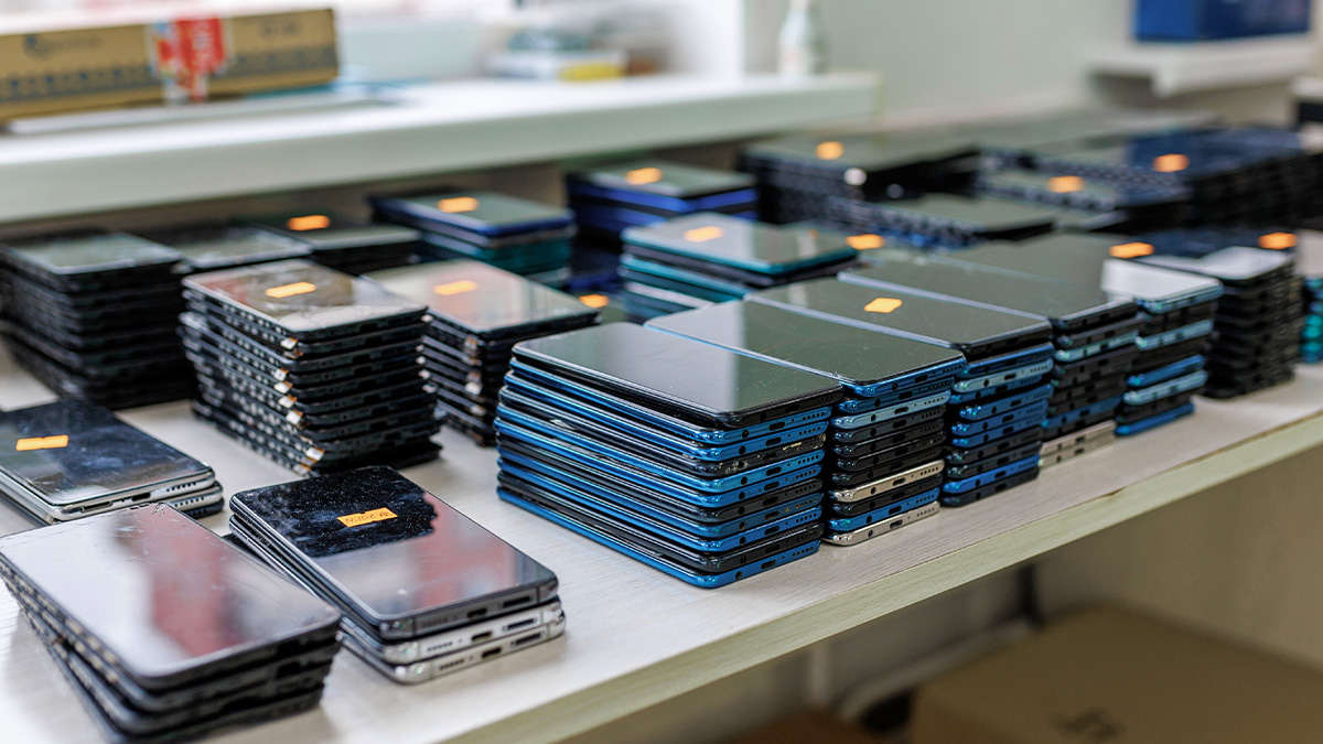 Confiscated contraband cellphones stacked on a table inside a U.S. corrections facility