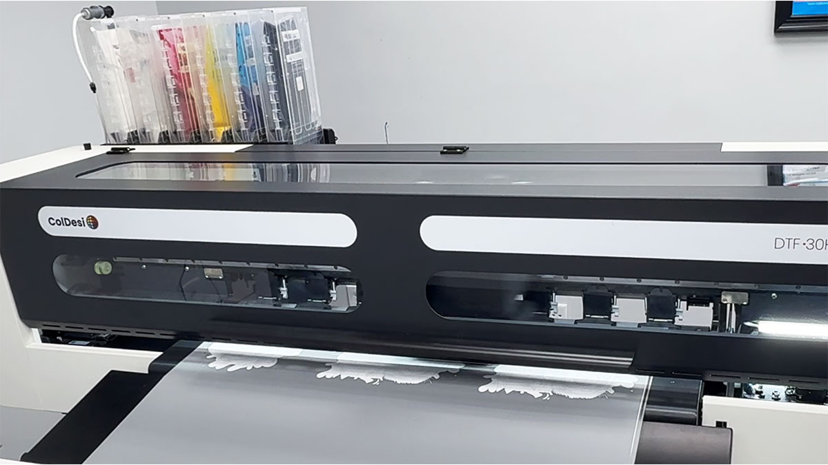 Close up of ColDesi DTF printer showing print output and ink cartridges