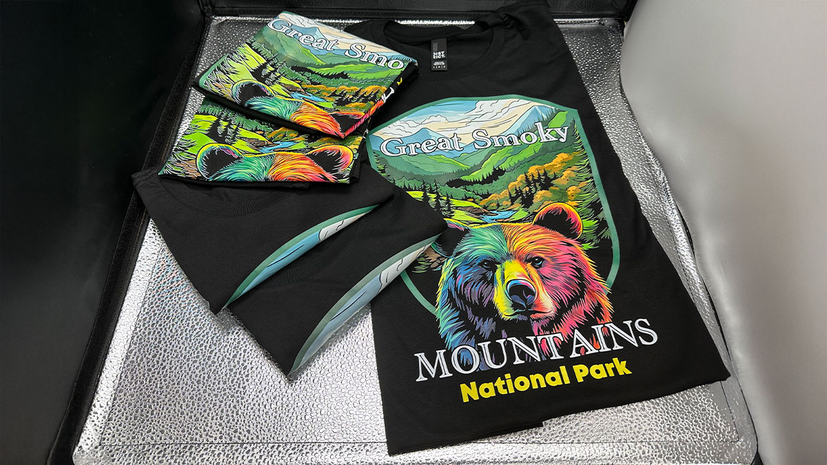 DTF printing design with a colorful logo of a bear representing mountains national park on black tshirt